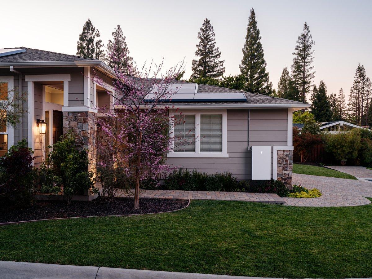 Tesla Powerwall 3 — sleek white home battery mounted on a wall